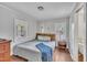 Cozy bedroom with hardwood floors, gray walls, and natural light at 9321 Stephenson Adams Ln, Willow Springs, NC 27592