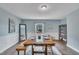 Cozy dining room with a wooden table set, large mirror, and hardwood flooring at 9321 Stephenson Adams Ln, Willow Springs, NC 27592