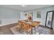 Inviting dining area with hardwood floors, a wooden table, and view into adjacent rooms at 9321 Stephenson Adams Ln, Willow Springs, NC 27592