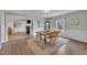Dining room featuring wood table, chairs, and a view into kitchen and outdoor scenery at 9321 Stephenson Adams Ln, Willow Springs, NC 27592