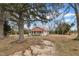 Charming home with a red roof, inviting porch and large trees in a spacious yard at 9321 Stephenson Adams Ln, Willow Springs, NC 27592