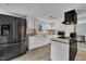 Well-lit kitchen with stainless steel appliances, white cabinetry, and ample counter space at 9321 Stephenson Adams Ln, Willow Springs, NC 27592