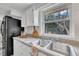 Bright kitchen featuring a double sink beneath a window providing an outside view at 9321 Stephenson Adams Ln, Willow Springs, NC 27592