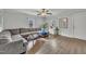 Bright living room with hardwood floors, sectional couch, and multiple windows at 9321 Stephenson Adams Ln, Willow Springs, NC 27592