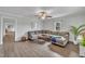 Spacious living room with hardwood floors, large sectional couch, and plenty of natural light at 9321 Stephenson Adams Ln, Willow Springs, NC 27592