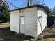 Outbuilding with white siding, a door and lamp in a spacious yard at 9321 Stephenson Adams Ln, Willow Springs, NC 27592
