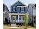Charming two-story blue home featuring a welcoming front porch and bright yellow front door at 934 Allen Park Dr, Knightdale, NC 27604