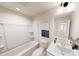 Bright bathroom with tub, white vanity and modern finishes and an artful decor at 936 Allen Park Dr, Raleigh, NC 27604
