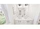 Bathroom features a double sink vanity, modern fixtures, and a large window at 936 Allen Park Dr, Raleigh, NC 27604