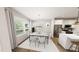 Dining room featuring an adjacent kitchen with stainless appliances and bright windows at 936 Allen Park Dr, Raleigh, NC 27604