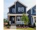 Charming two-story home featuring a welcoming front porch with beautiful landscaping and a modern color scheme at 936 Allen Park Dr, Raleigh, NC 27604