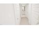 Bright hallway with white doors and carpet flooring, leading to a bathroom and other rooms at 936 Allen Park Dr, Raleigh, NC 27604