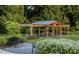 Well manicured community pavilion with outdoor seating, a grilling area and lush landscaping at 936 Allen Park Dr, Raleigh, NC 27604