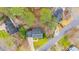 Aerial view of a home nestled among lush greenery, showcasing its roof, yard, and surrounding neighborhood at 112 Parkmeadow Dr, Cary, NC 27519