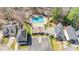 An aerial view of a home with a swimming pool, manicured lawns, mature trees, and surrounding neighborhood at 112 Parkmeadow Dr, Cary, NC 27519