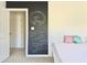Bedroom with chalkboard wall design, white door and simple decor elements at 112 Parkmeadow Dr, Cary, NC 27519