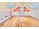 Attic bonus room featuring wood floors, a skylight and painted built in shelving at 112 Parkmeadow Dr, Cary, NC 27519