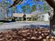 View of the community clubhouse and parking area, framed by a blooming tree at 112 Parkmeadow Dr, Cary, NC 27519