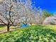 Beautiful community features flowering trees, green grass, and water at 112 Parkmeadow Dr, Cary, NC 27519