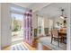 Dining area with a view of the front yard, featuring modern lighting, and an eye-catching purple front door at 112 Parkmeadow Dr, Cary, NC 27519