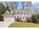 Charming two-story home with a well-manicured lawn, two-car garage, and inviting purple front door at 112 Parkmeadow Dr, Cary, NC 27519