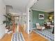 Inviting foyer with hardwood floors, staircase, and a view into the living room with stylish decor at 112 Parkmeadow Dr, Cary, NC 27519