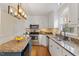 Modern kitchen with granite countertops, stainless steel appliances, and custom cabinetry at 112 Parkmeadow Dr, Cary, NC 27519