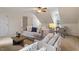Bright living room featuring modern furnishings, neutral colors, and a ceiling fan at 112 Parkmeadow Dr, Cary, NC 27519