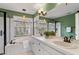 Bright bathroom with a soaking tub, double sinks, and green accent wall at 112 Parkmeadow Dr, Cary, NC 27519