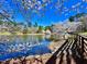 Scenic view of a serene pond surrounded by lush trees and cherry blossoms on a bright, sunny day at 112 Parkmeadow Dr, Cary, NC 27519