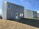 This backyard has a sliding glass door leading to a concrete patio and an expansive yard at 1161 Centerview Drive, Nashville, NC 27856