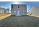 This backyard has a sliding glass door leading to a concrete patio and an expansive yard at 1161 Centerview Drive, Nashville, NC 27856