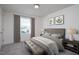 Cozy bedroom with soft gray carpet, a comfortable bed, and plenty of natural light from the window at 1161 Centerview Drive, Nashville, NC 27856