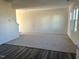 Bright living room featuring neutral carpet, white walls, and three large windows providing ample natural light at 1161 Centerview Drive, Nashville, NC 27856