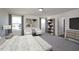 This main bedroom features two large windows, two white chairs with art in between, and a bookshelf for storage at 1161 Centerview Drive, Nashville, NC 27856