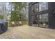 View of wooden back deck leading to the house with large sliding glass doors and modern architecture at 118 Flora Mcdonald Ln, Cary, NC 27511