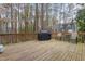 View of wooden back deck featuring outdoor grill, chairs, and wooden railings at 118 Flora Mcdonald Ln, Cary, NC 27511