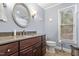 Charming bathroom with a granite vanity top, decorative mirror, and neutral color scheme at 118 Flora Mcdonald Ln, Cary, NC 27511