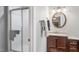 Well-lit bathroom with shower and vanity featuring round mirror at 118 Flora Mcdonald Ln, Cary, NC 27511