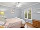 Bright bedroom with hardwood floors, ceiling fan, and serene color palette at 118 Flora Mcdonald Ln, Cary, NC 27511
