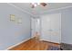 Bedroom with hardwood floors, closet, and neutral color scheme for relaxation and comfort at 118 Flora Mcdonald Ln, Cary, NC 27511