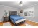 Well-lit bedroom features a dark wood bedframe, bench, and hardwood floors at 118 Flora Mcdonald Ln, Cary, NC 27511