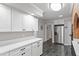 Kitchen featuring white cabinets, dark tile floors, and stainless steel appliances at 118 Flora Mcdonald Ln, Cary, NC 27511