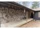 Inviting covered porch featuring stone facade, outdoor seating, string lights, and wooden deck at 118 Flora Mcdonald Ln, Cary, NC 27511