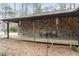 Inviting covered porch featuring stone facade, outdoor seating, string lights, and wooden deck at 118 Flora Mcdonald Ln, Cary, NC 27511
