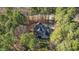 Aerial view showcasing the home's layout, surrounding trees, driveway, and landscaped backyard at 1196 Smith Creek Way, Wake Forest, NC 27587