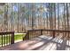 Private wooden back deck overlooks a spacious backyard surrounded by mature trees at 1196 Smith Creek Way, Wake Forest, NC 27587
