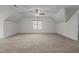 Large bonus room with neutral carpet, ceiling fan, and bright, natural light at 1196 Smith Creek Way, Wake Forest, NC 27587