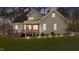 Exterior view of home featuring deck, screened-in porch, and lush landscaping at 1196 Smith Creek Way, Wake Forest, NC 27587