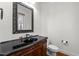 Elegant half bathroom features a dark vanity, granite countertop, and decorative mirror at 1196 Smith Creek Way, Wake Forest, NC 27587